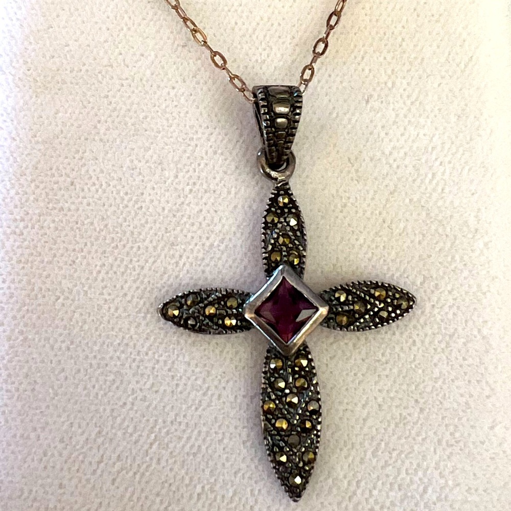 Marcasite cross on silver chain, amethyst stone in the center.
